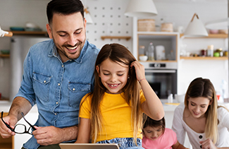 A father having fun helping daughter with homework