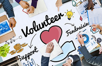 Parents at a table with volunteer opportunities