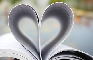 Opened book with pages folded into the shape of a heart
