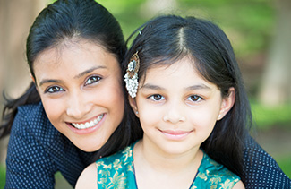 Mom and daughter smiling for the camera
