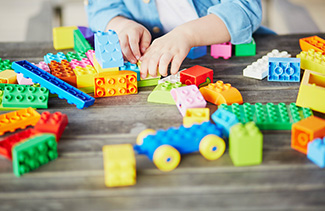 Preschool student playing with LEGO blocks
