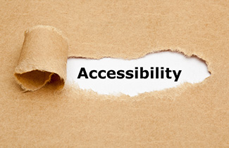 The word Accessibility being revealed under brown paper